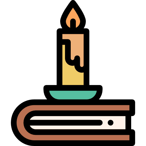 A lit candle in a holder rests on top of a closed book.