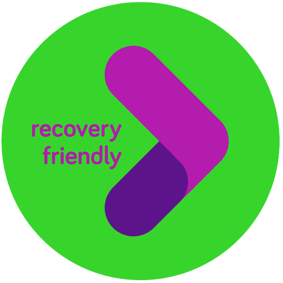 A green circle with a purple and magenta arrow pointing right, and the words “recovery friendly” in purple on the left side of the design.